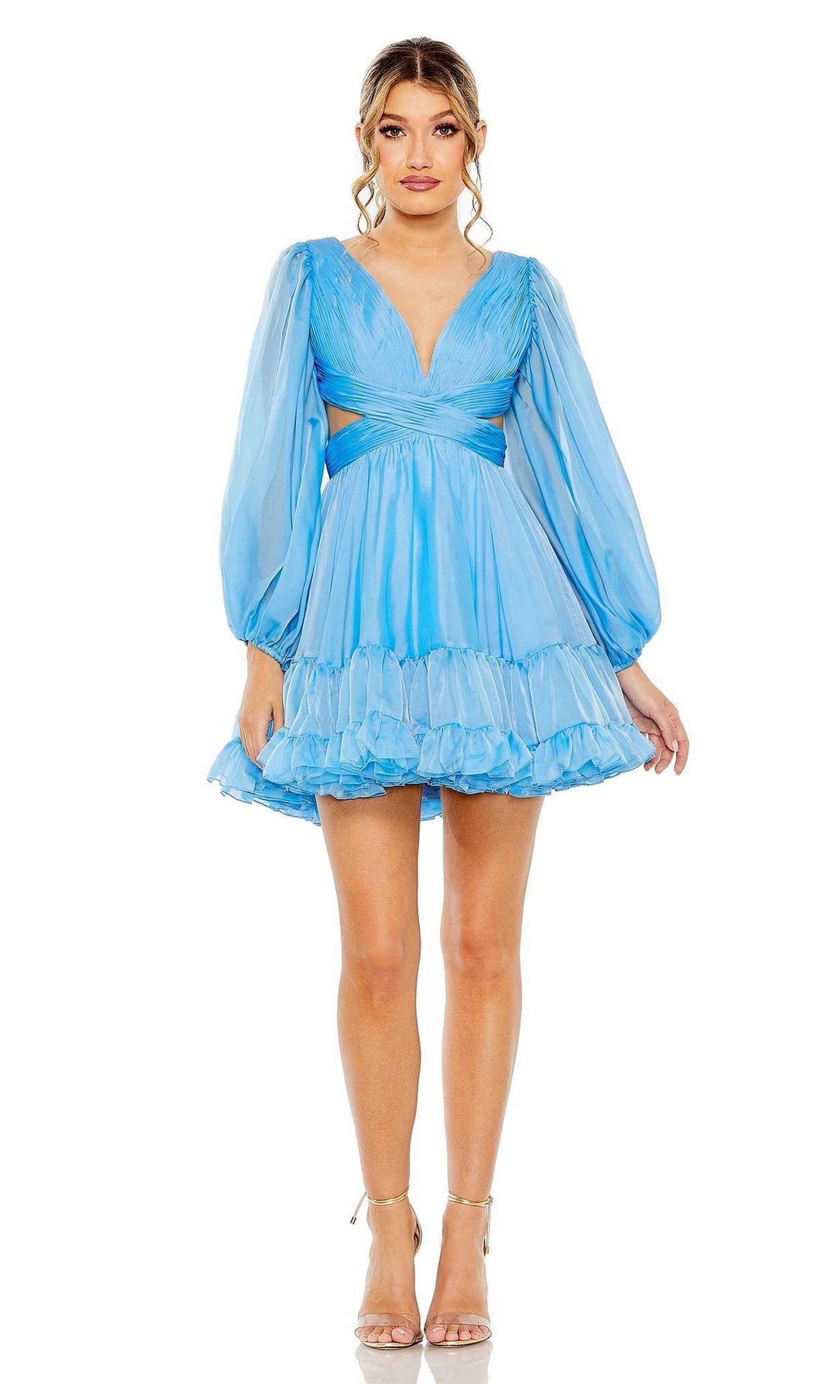 A woman stands in strappy heels against a white background, wearing the Mac Duggal 68451 Short Blue Ruffle Party Dress with puff sleeves, a deep V-neckline, cutout waist, and ruffled skirt—perfect for any party.
